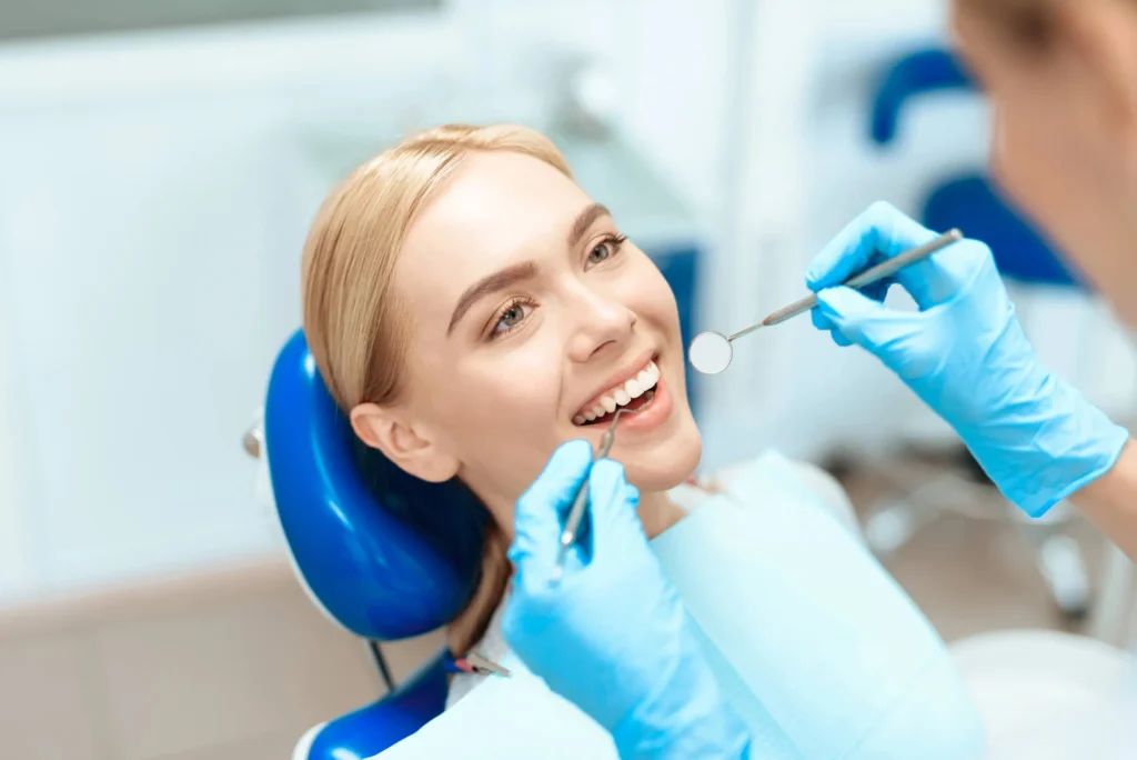 cosmetic dentist pembroke pines checking pateint's teeth