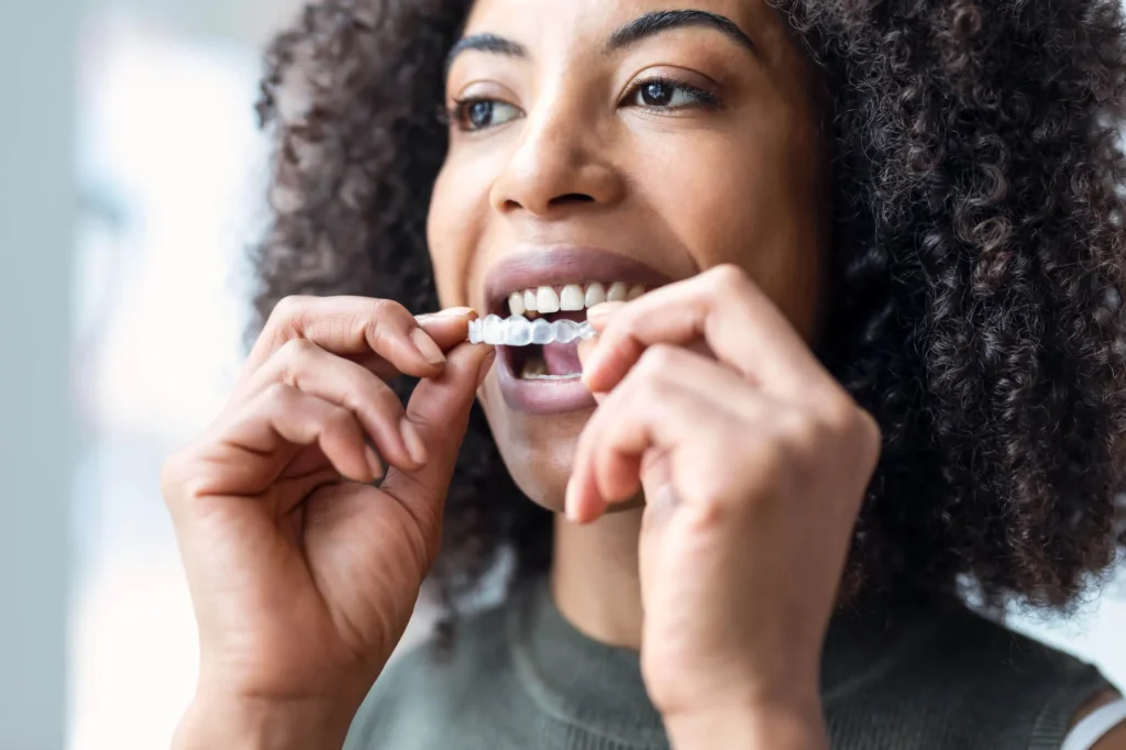 woman wearing clear aligners after visiting her orthodontist pembroke pines fl