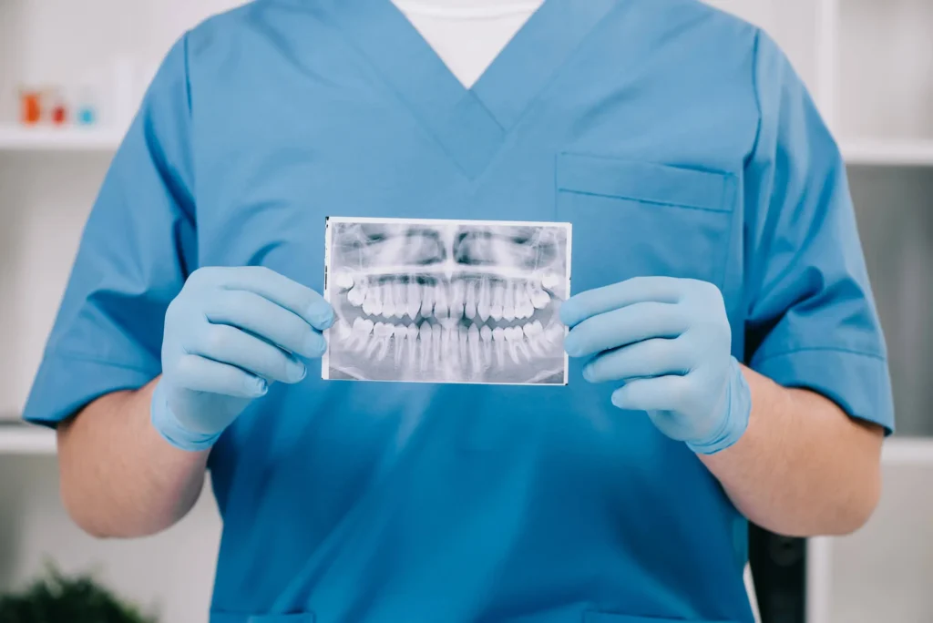 orthodontist in miramar fl holding an Xray image